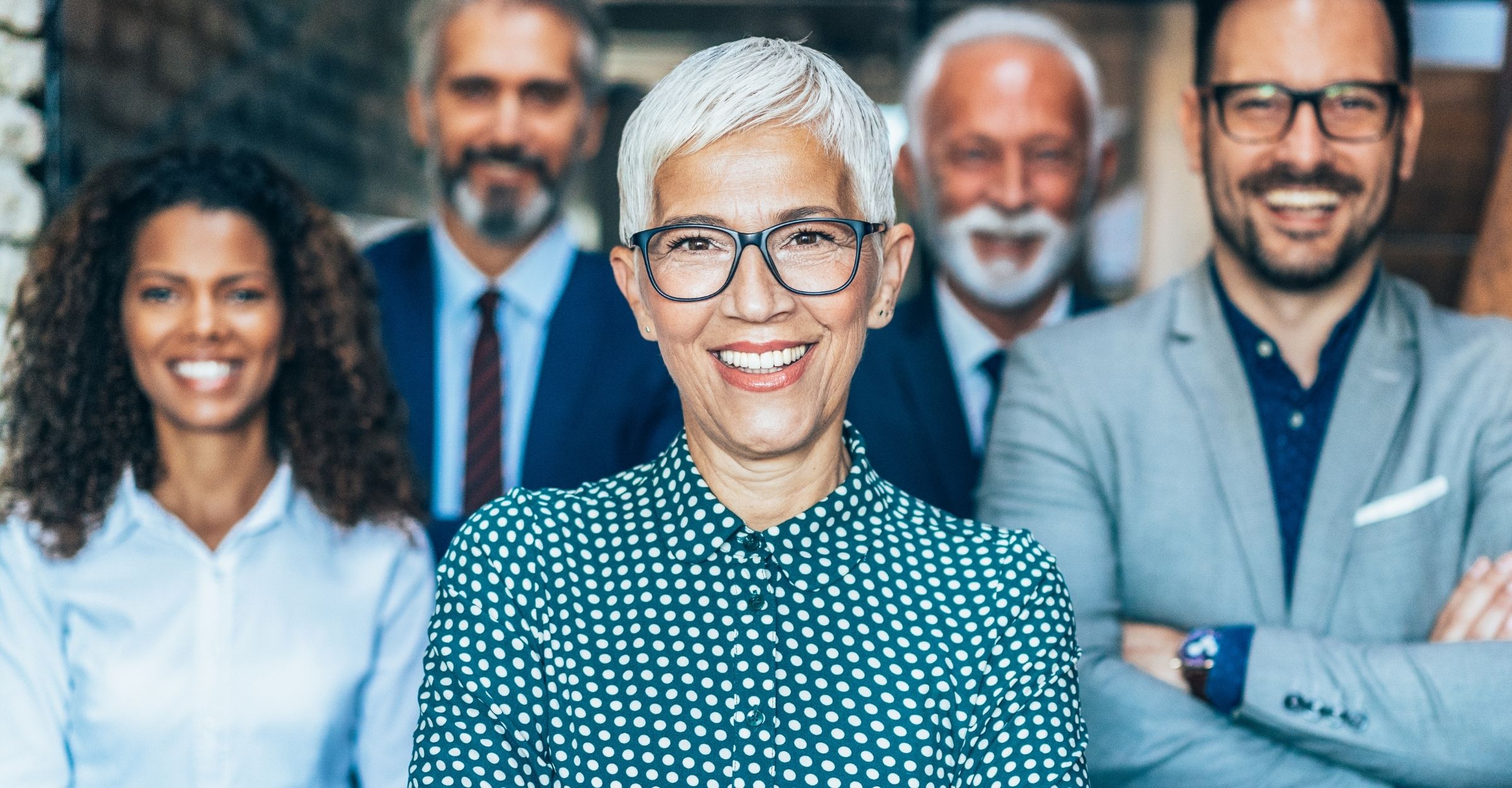 Nonprofit president and her team smiling proudly after working with FPLG attorneys for nonprofit organizations